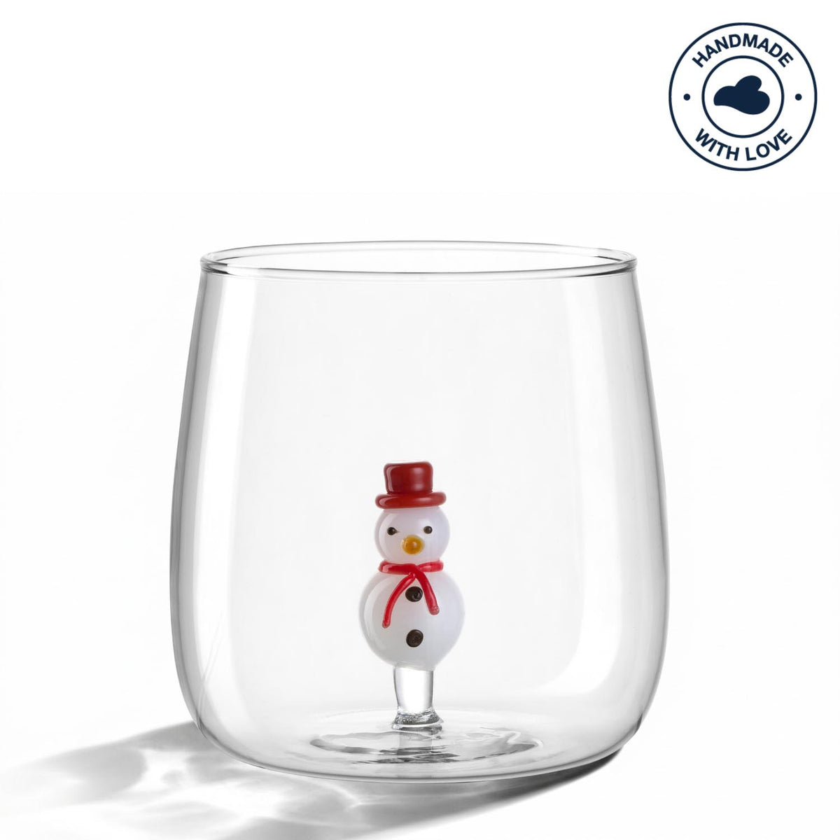 Trinkglas RIPOSO mit Schneemann-Figur am Boden, klares Glas, Studioaufnahme