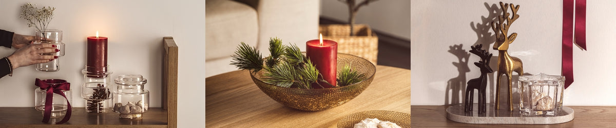 Weihnachtliche Dekoration mit roten Kerzen, Glasvasen, Holzschalen mit Tannengrün und dekorativen Hirschfiguren in Weiß und Gold