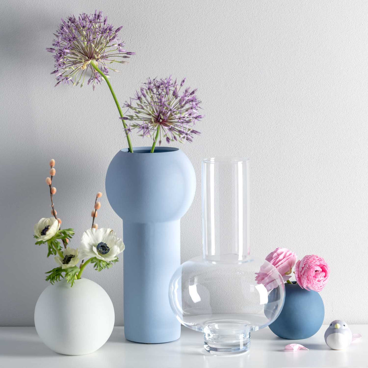 Vase VERNAZZO klar mit anderen Vasen und Blumenstraußen in Stillleben-Arrangement