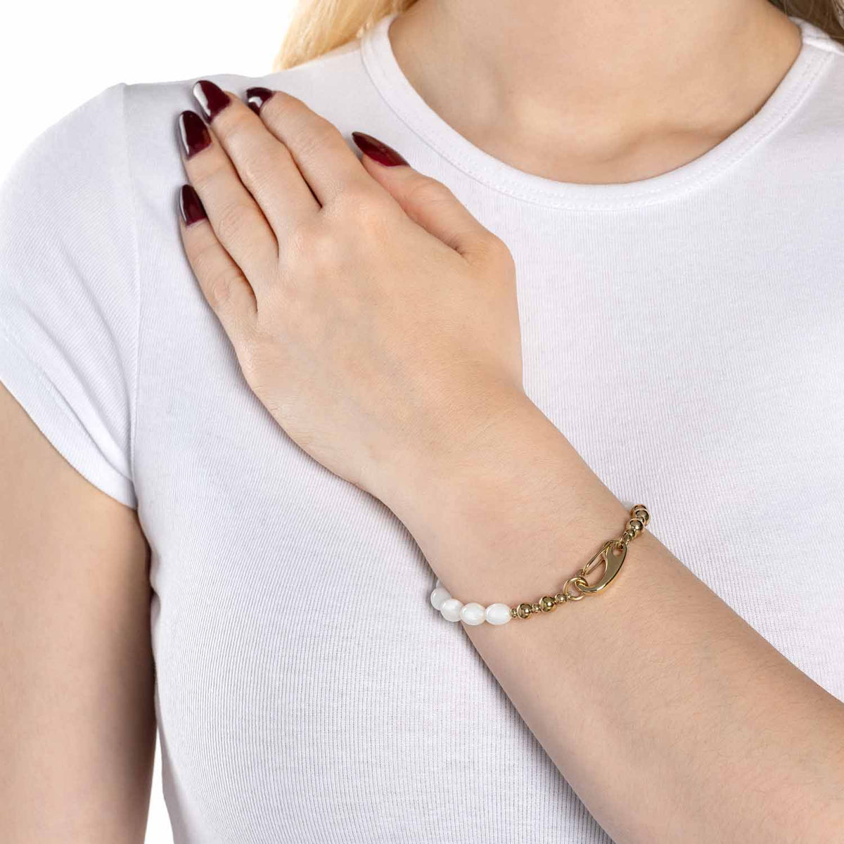 Frau trägt Armband PATSY gold mit Muscheln am Handgelenk